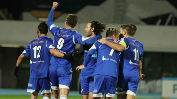 South Melbourne players celebrate a goal against Melbourne Knights.